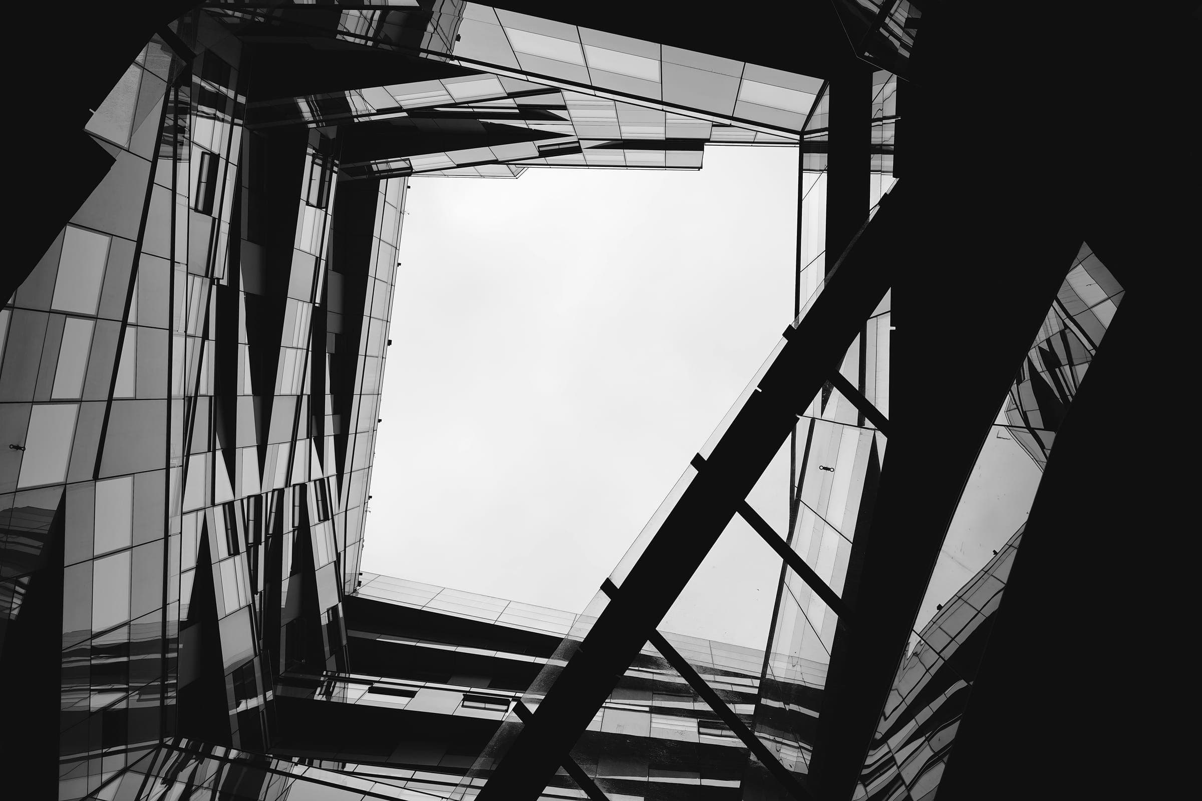 Glass towers seen from below, in black and white