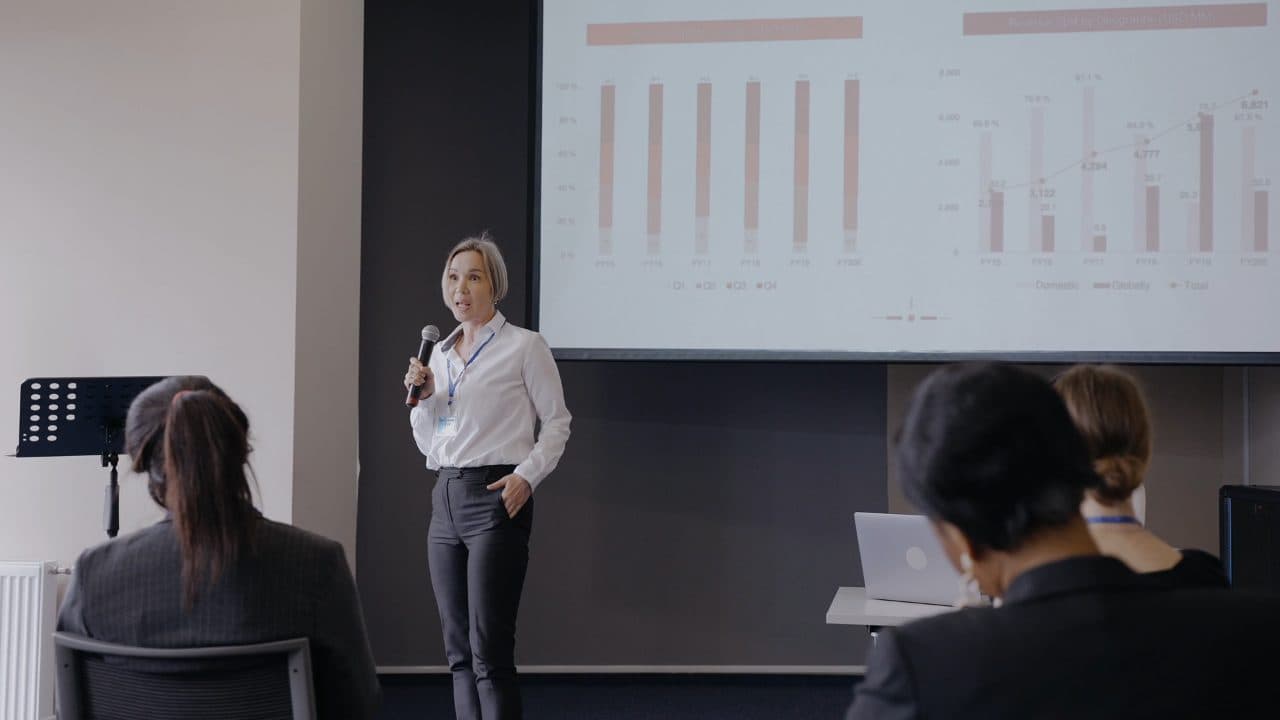 A consultant presenting charts to a conference room