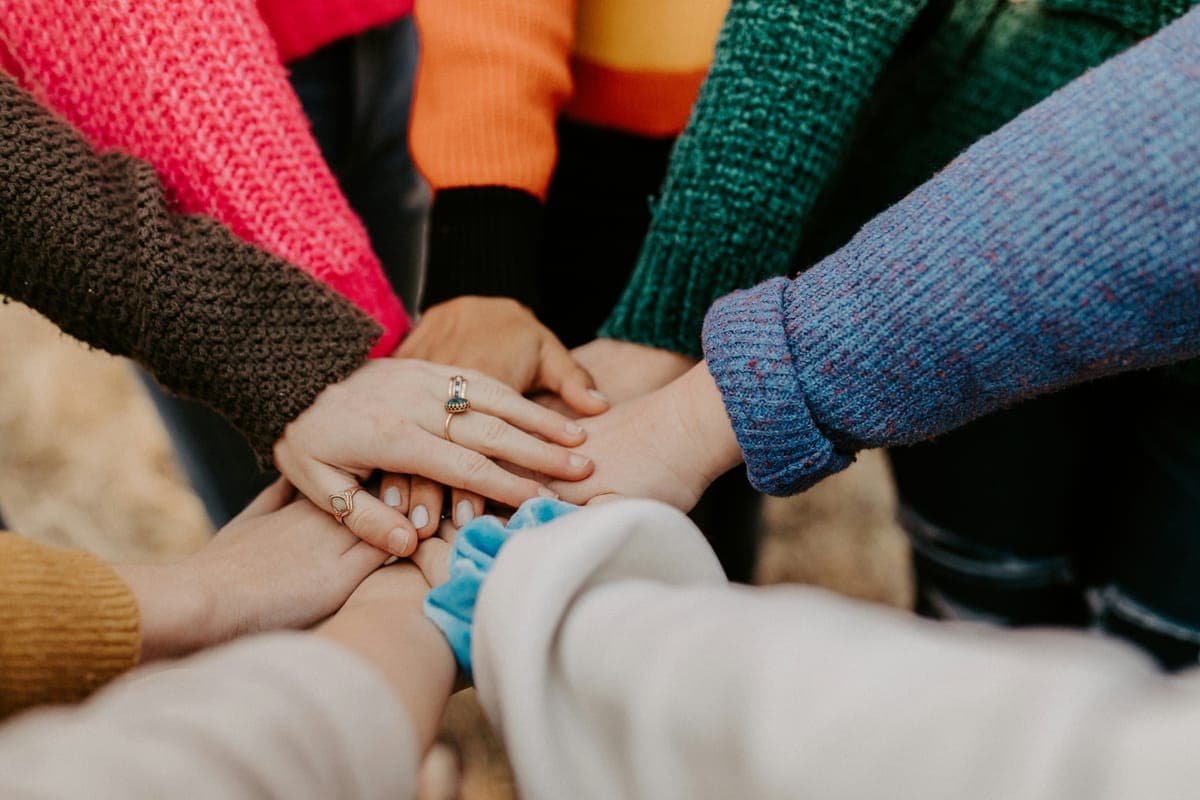 A group of colleagues stacking their hands together